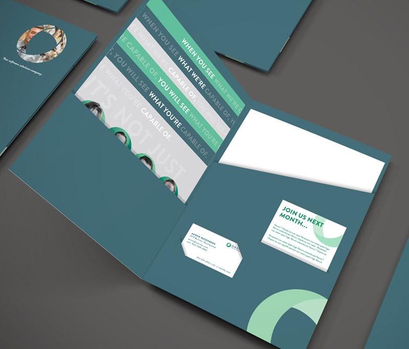 Oasis promotional folder with business cards and informational sheets.