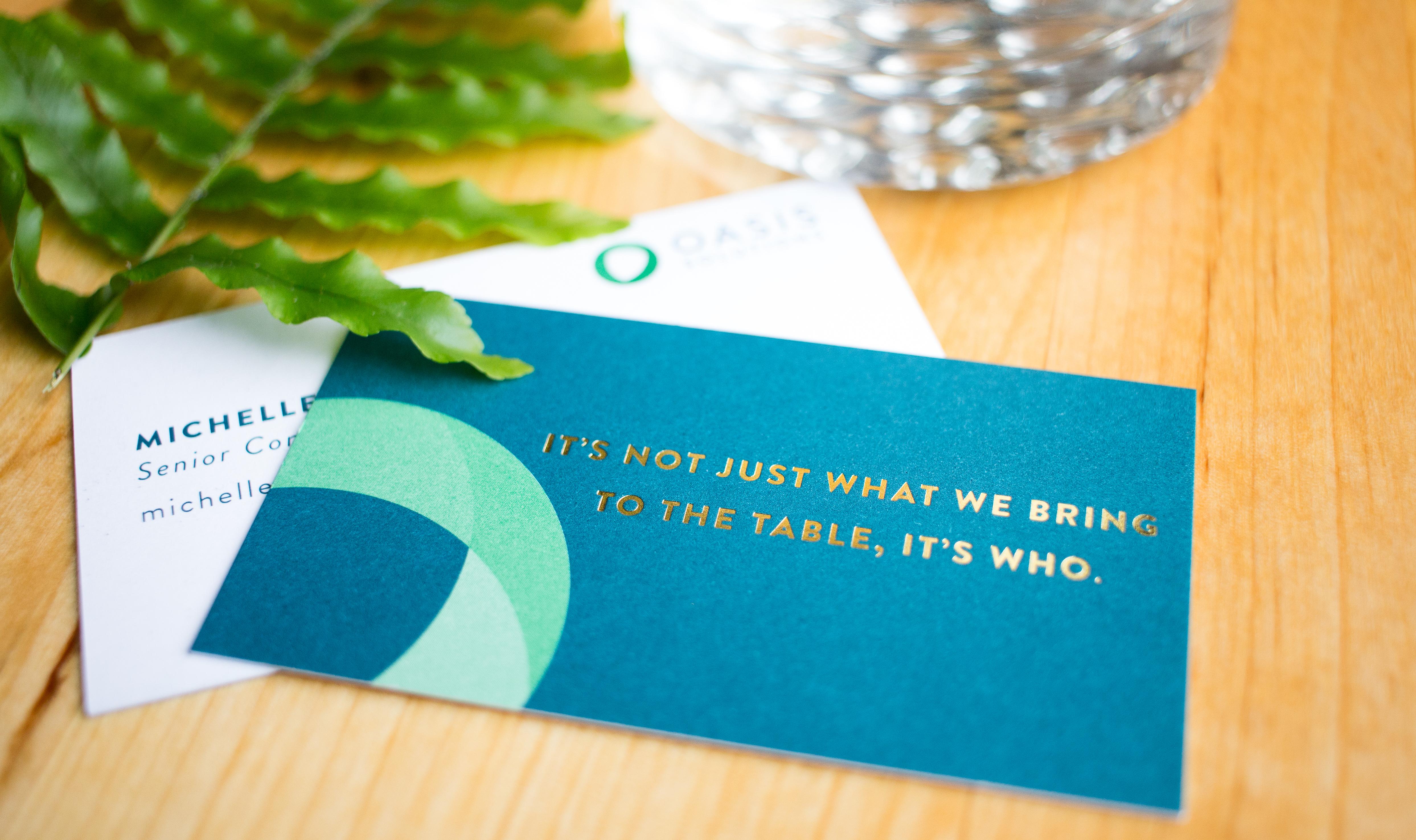 "It's not just what we bring to the table, it's who" Oasis business card.