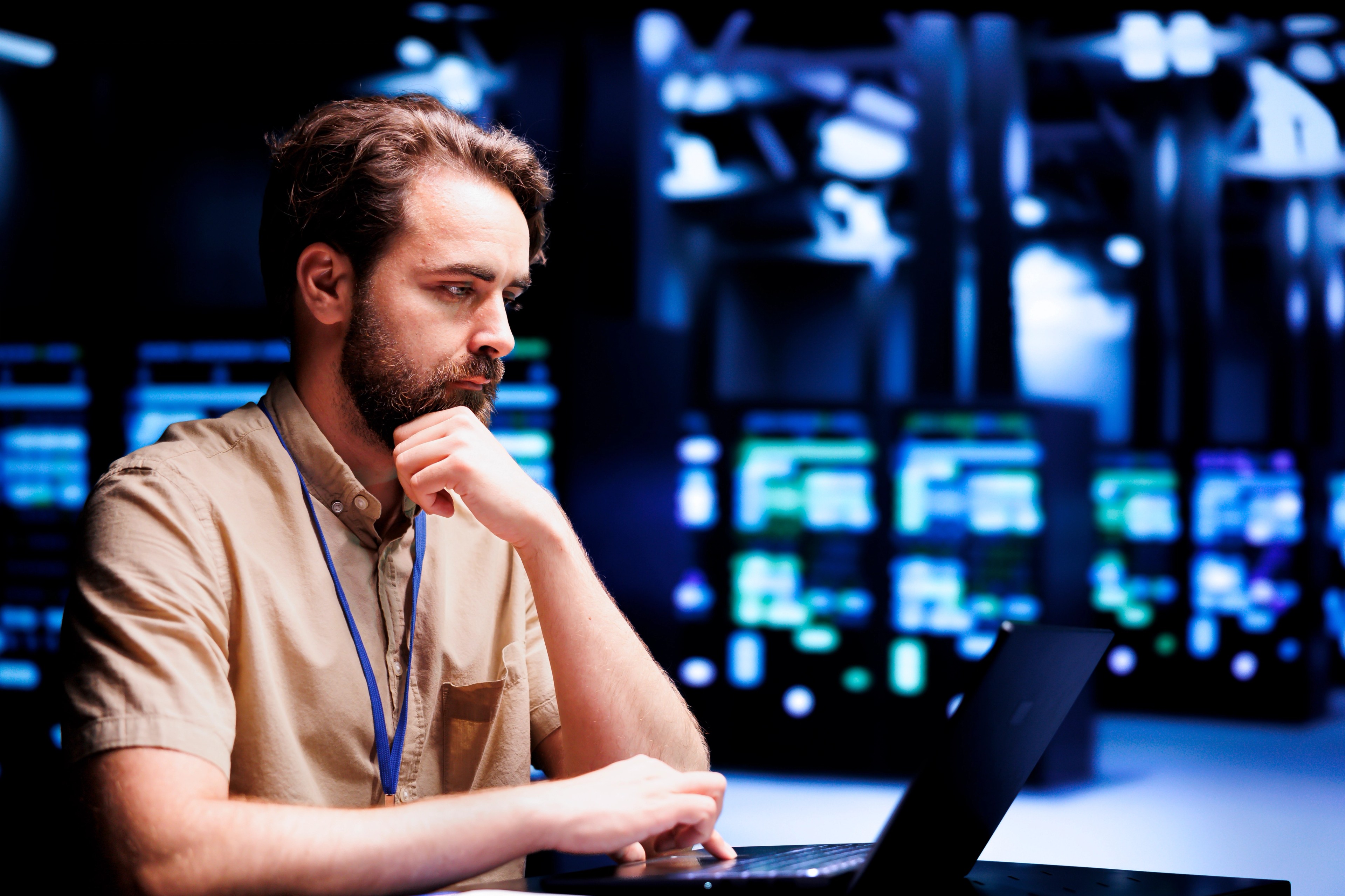 Man looking at computer screen in tech environment