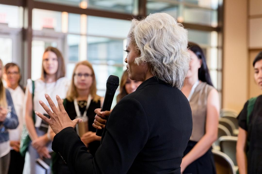female compliance leader discussing the importance of a culture of integrity with employees
