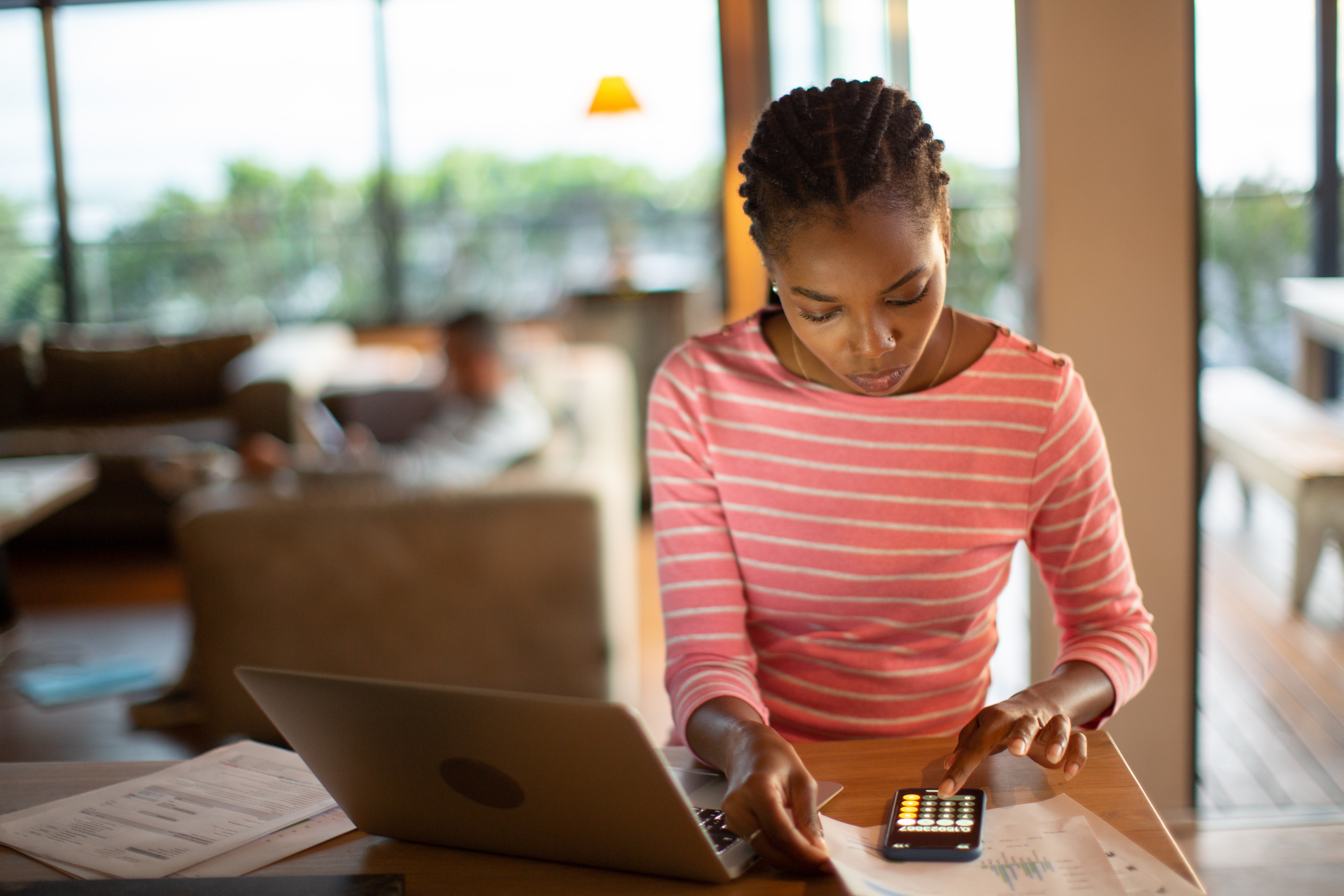 Young woman working on finances at a laptop
