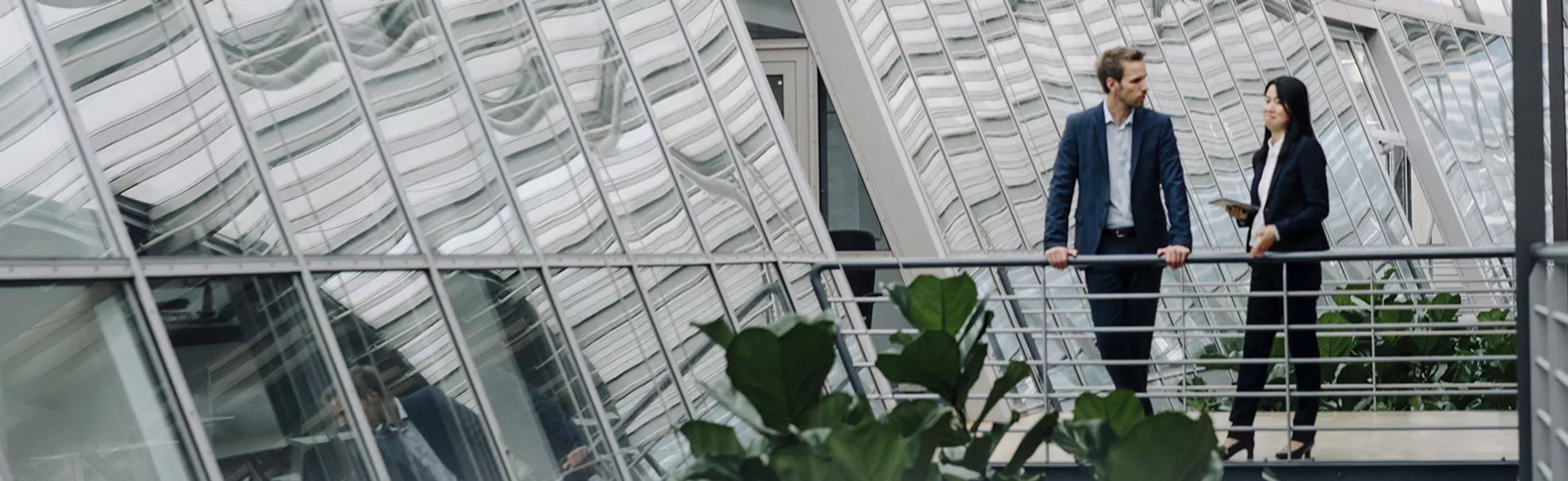 Two people discussing regulatory compliance