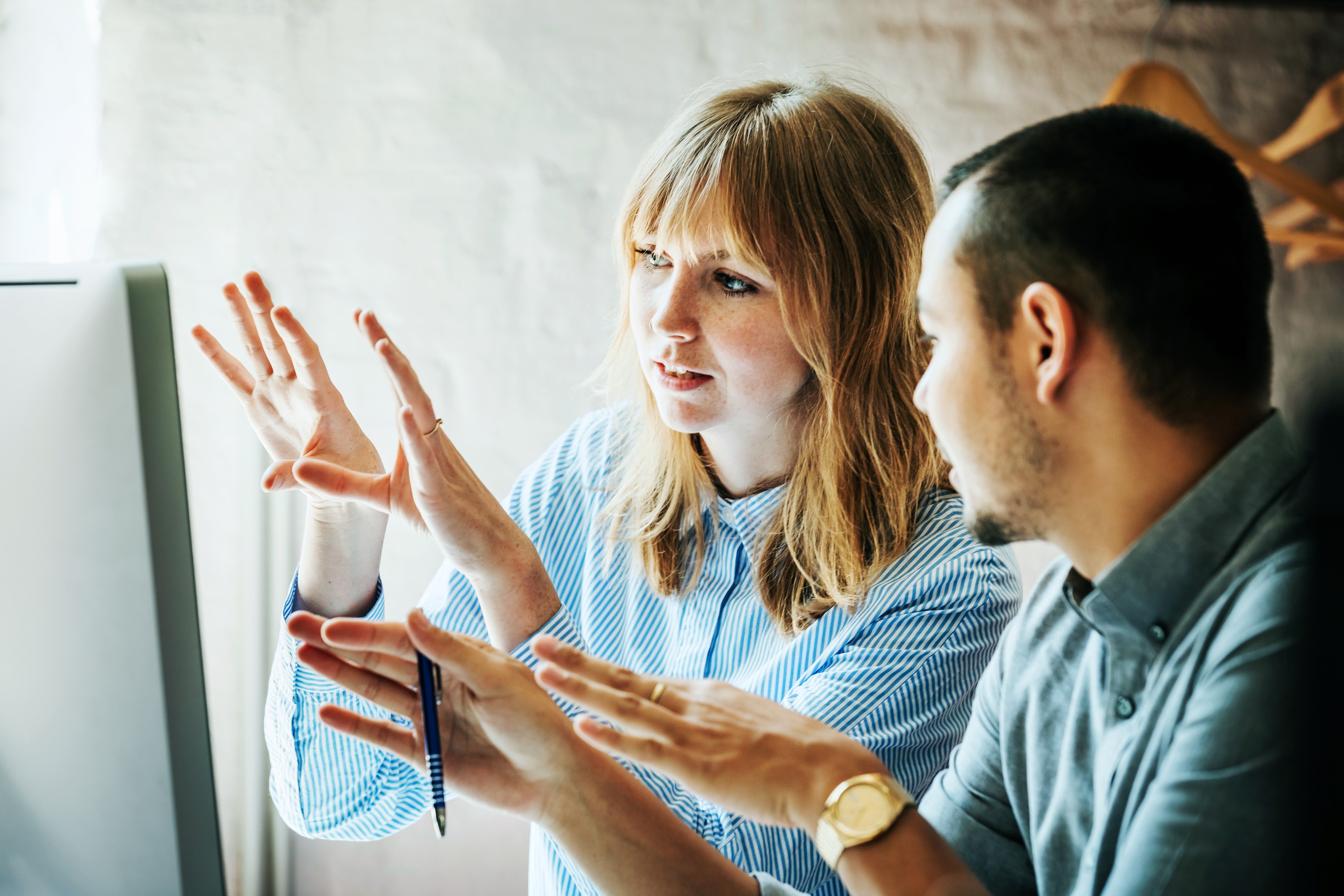 Colleagues problem solving at a computer together