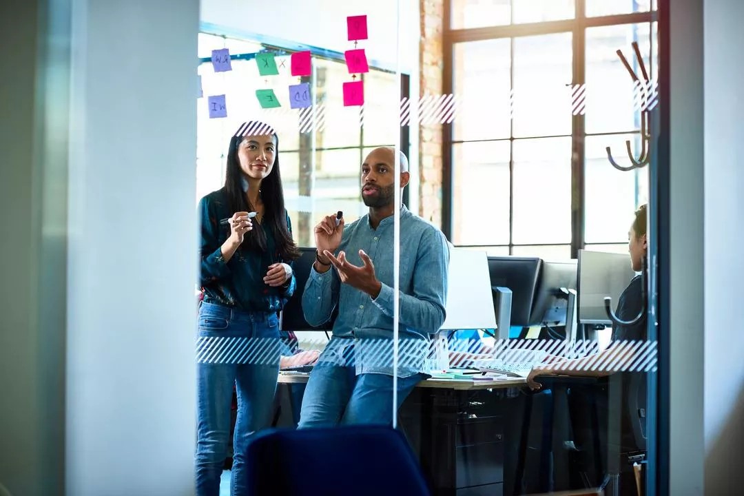 A group of people at an office work through harassment prevention training