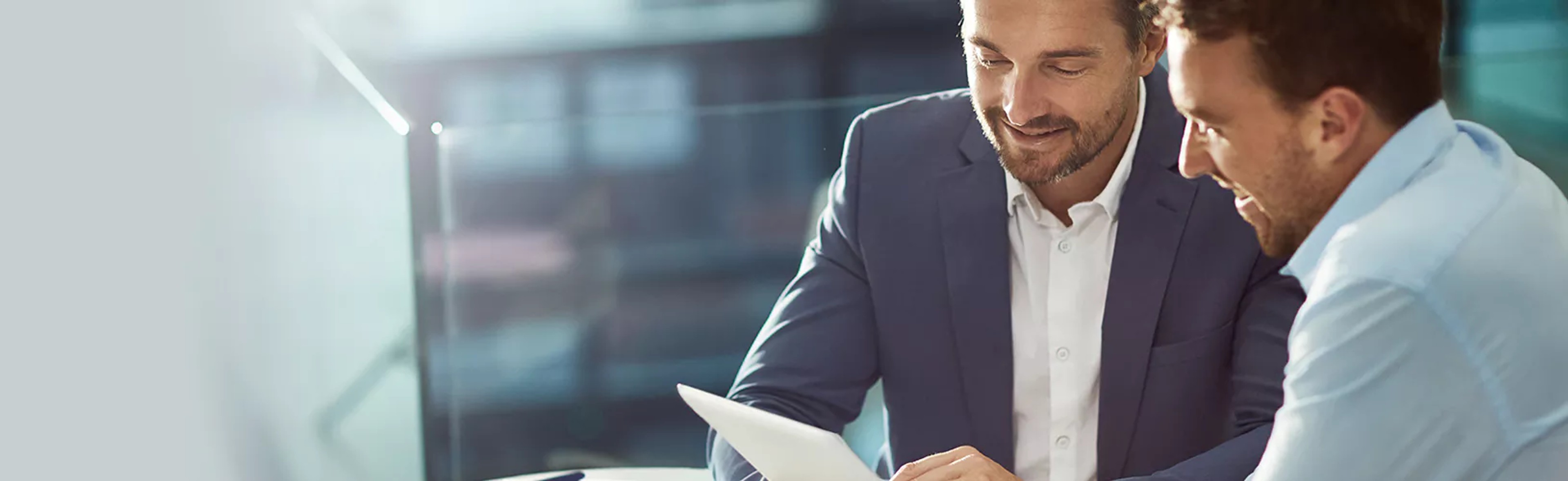 Two compliance professionals assessing CIS compliance benchmarks and identifying how best to comply.