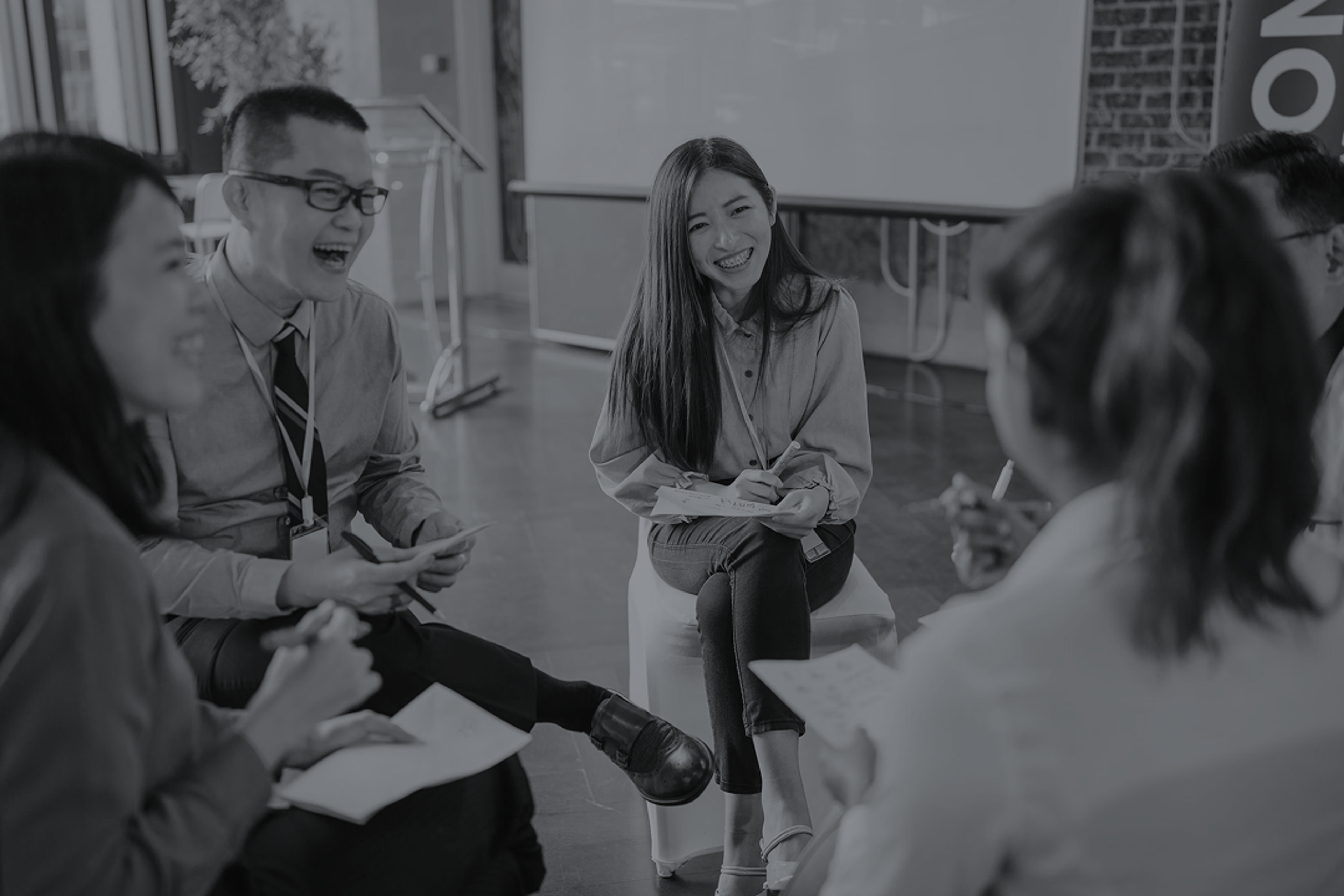 A group of coworkers laughing and brainstorming ideas durin