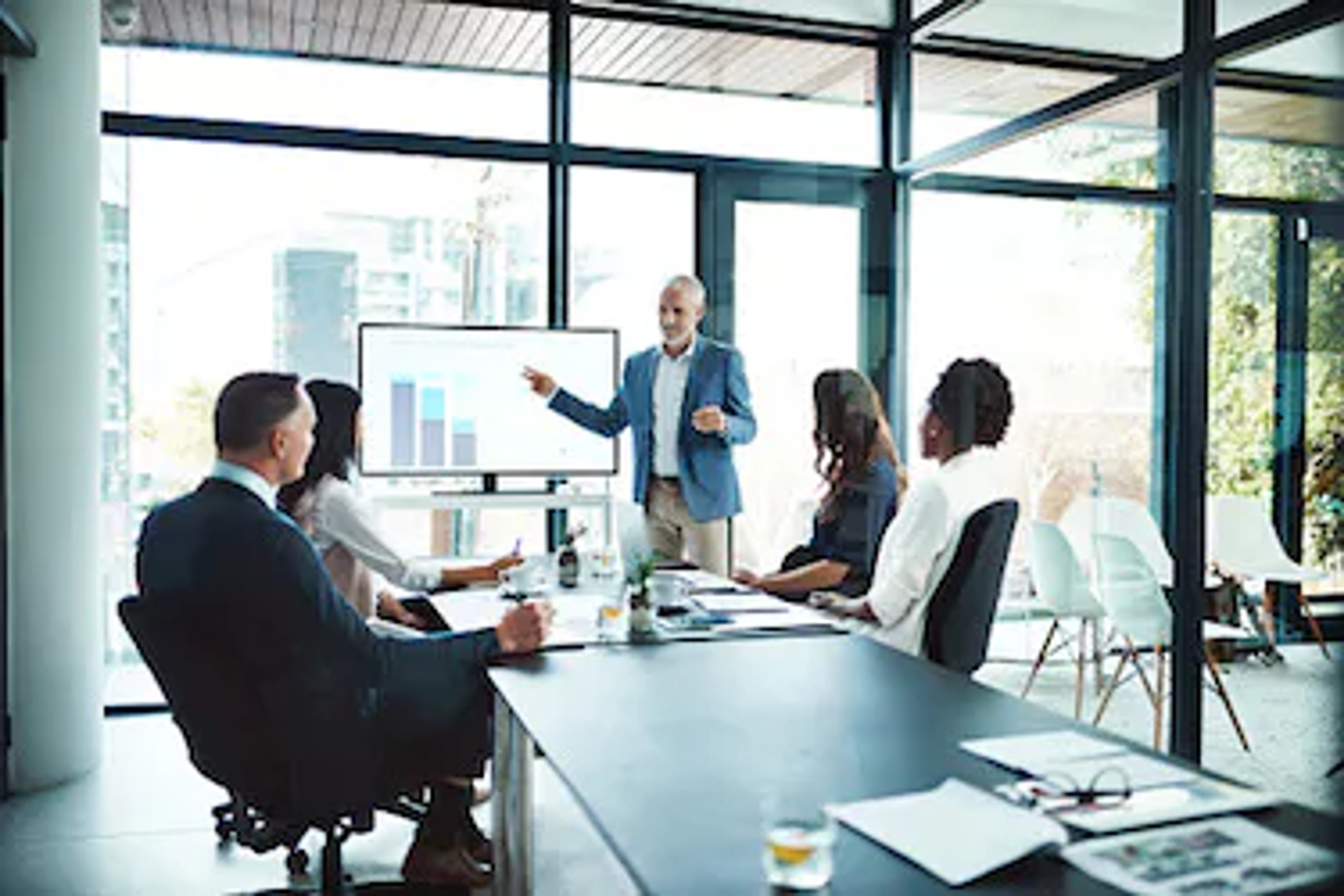 Professionals in a boardroom discussing the role of board committees.