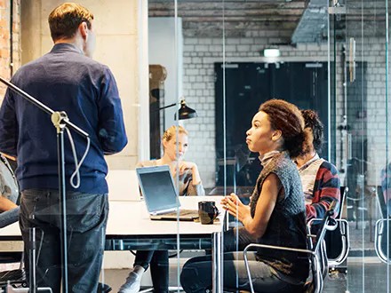 Coworkers discussing ways to implement audit software into their organization