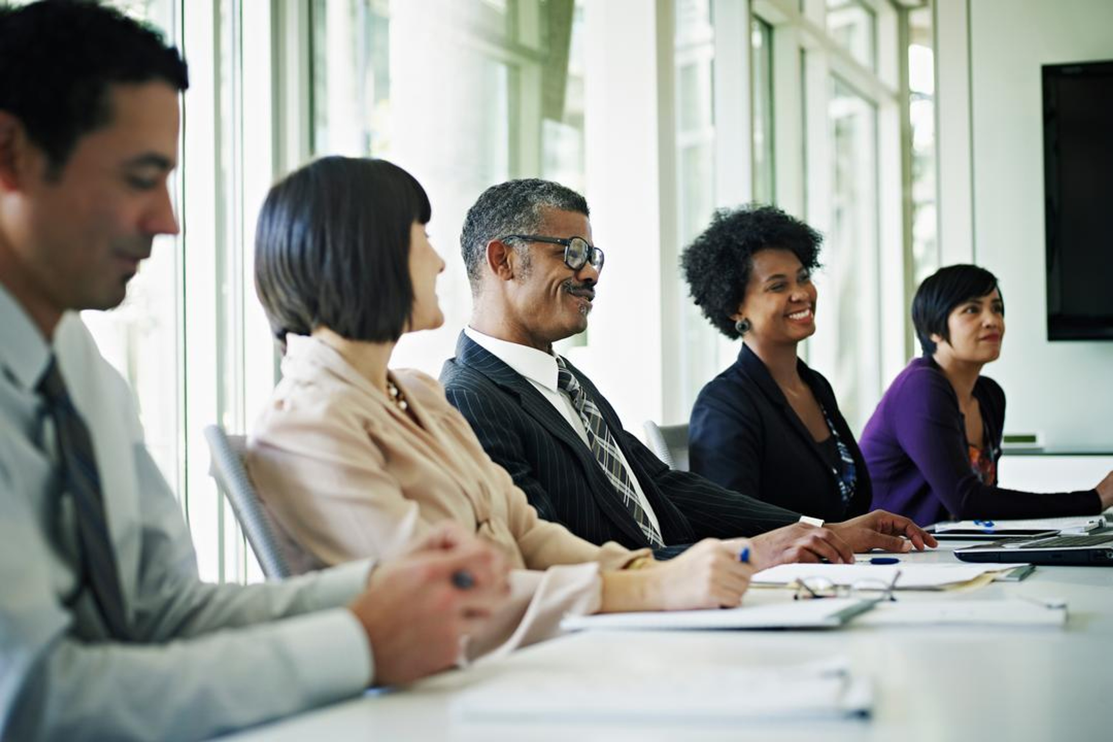 group of diverse board members having a discussion at a table