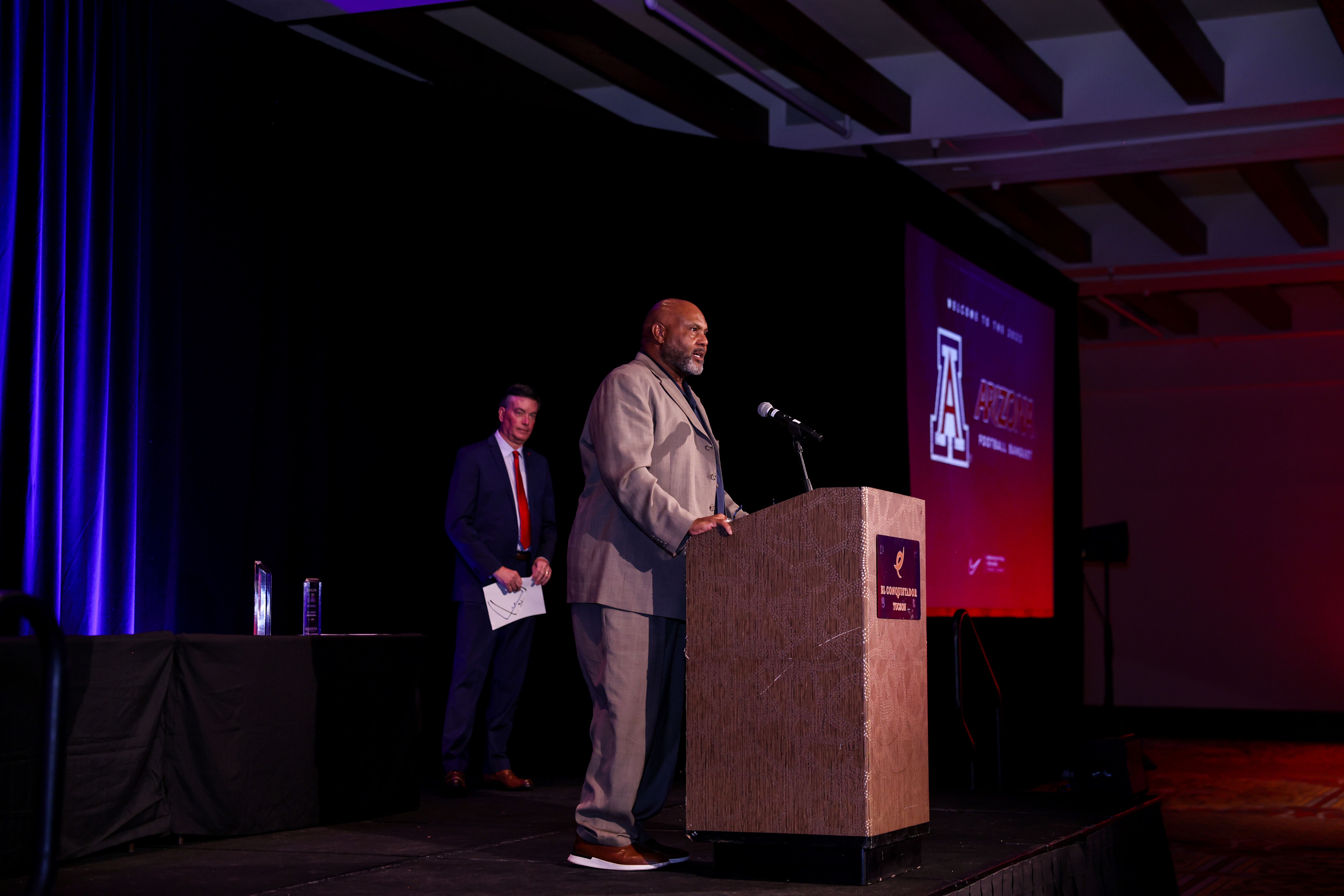 Ricky Hunley speaking from the podium at an Arizona football awards banquet