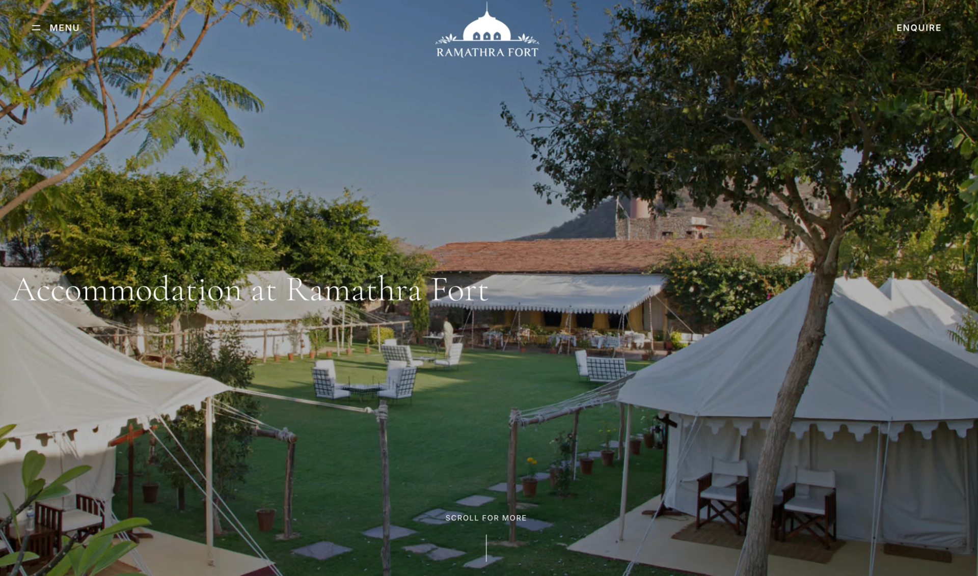 Ramathra Fort accommodation page hero showing luxury tents on a courtyard lawn below the fort