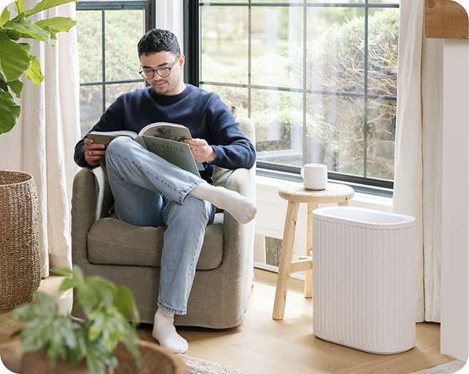 Person relaxing beside the Windmill Air Purifier Max