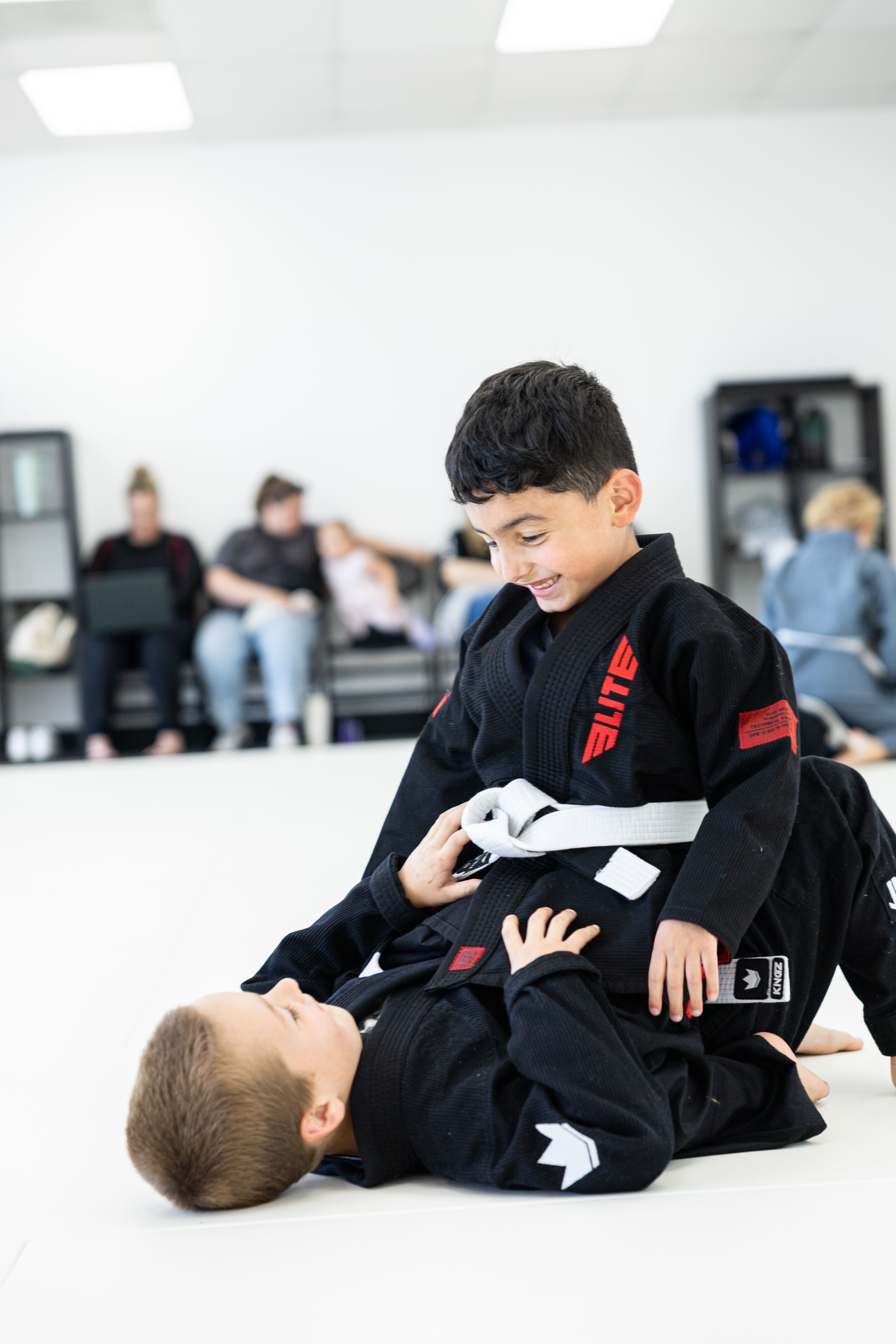Student smiling while training jiu-jitsu at Via Jiu Jitsu