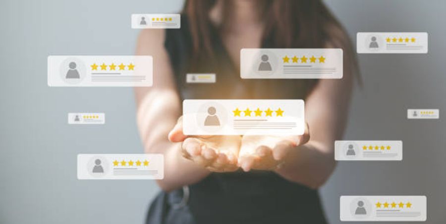 Person holding floating five star customer review cards representing online ratings and social proof