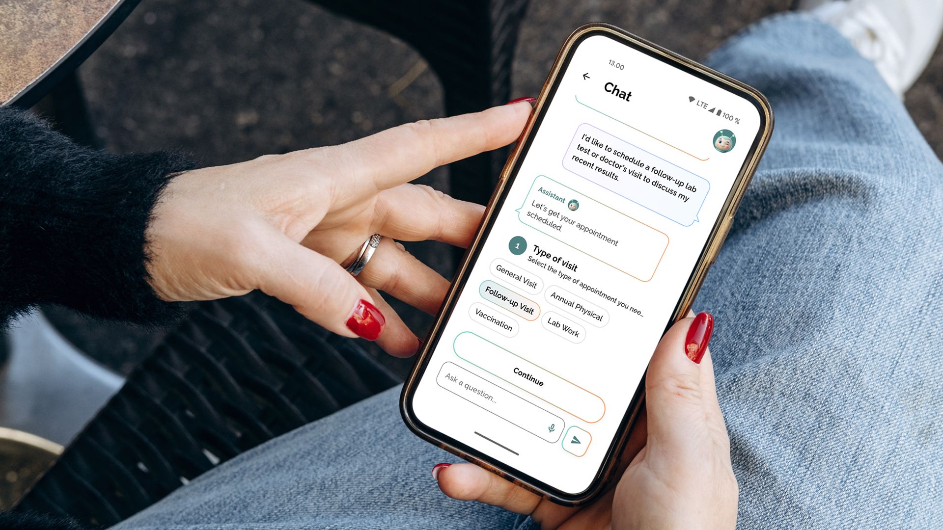 Person holding a smartphone showing a healthcare chat interface, where a user requests a follow-up appointment and the assistant guides them to select visit types like general visit, lab work, or vaccination.