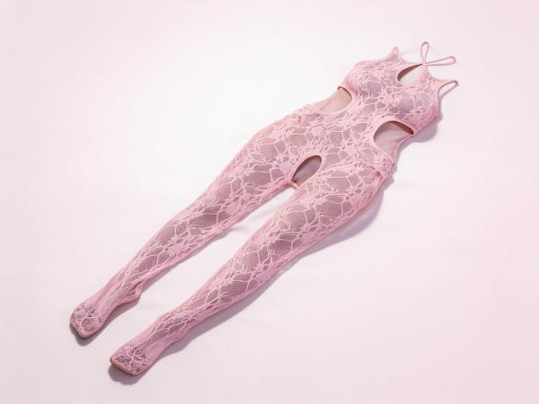 Pale pink floral lace GLOW Equilibrium crotchless bodystocking in queen size, laid flat on a soft blush ground, showing the halter teardrop neckline, open waist cut-outs and lace legs with closed feet