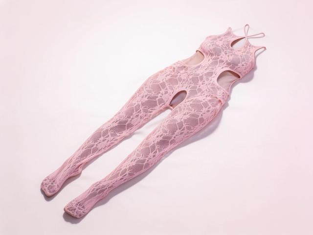 Pale pink floral lace GLOW Equilibrium crotchless bodystocking in queen size, laid flat on a soft blush ground, showing the halter teardrop neckline, open waist cut-outs and lace legs with closed feet