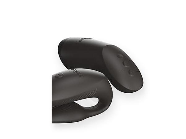 The We-Vibe Chorus Pro couples vibrator and its haptic squeeze remote, shown close in matte black silicone against a bright white background.