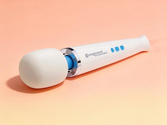 The cordless Magic Wand Rechargeable intimate massager resting on its side in warm coral daylight, completely free of any cord or charging base, ready to go wherever the moment takes you.