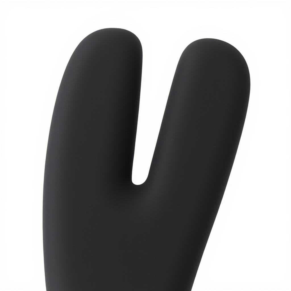 An abstract macro of a matte black form splitting into two rounded tips, crossed by a slim gold band.