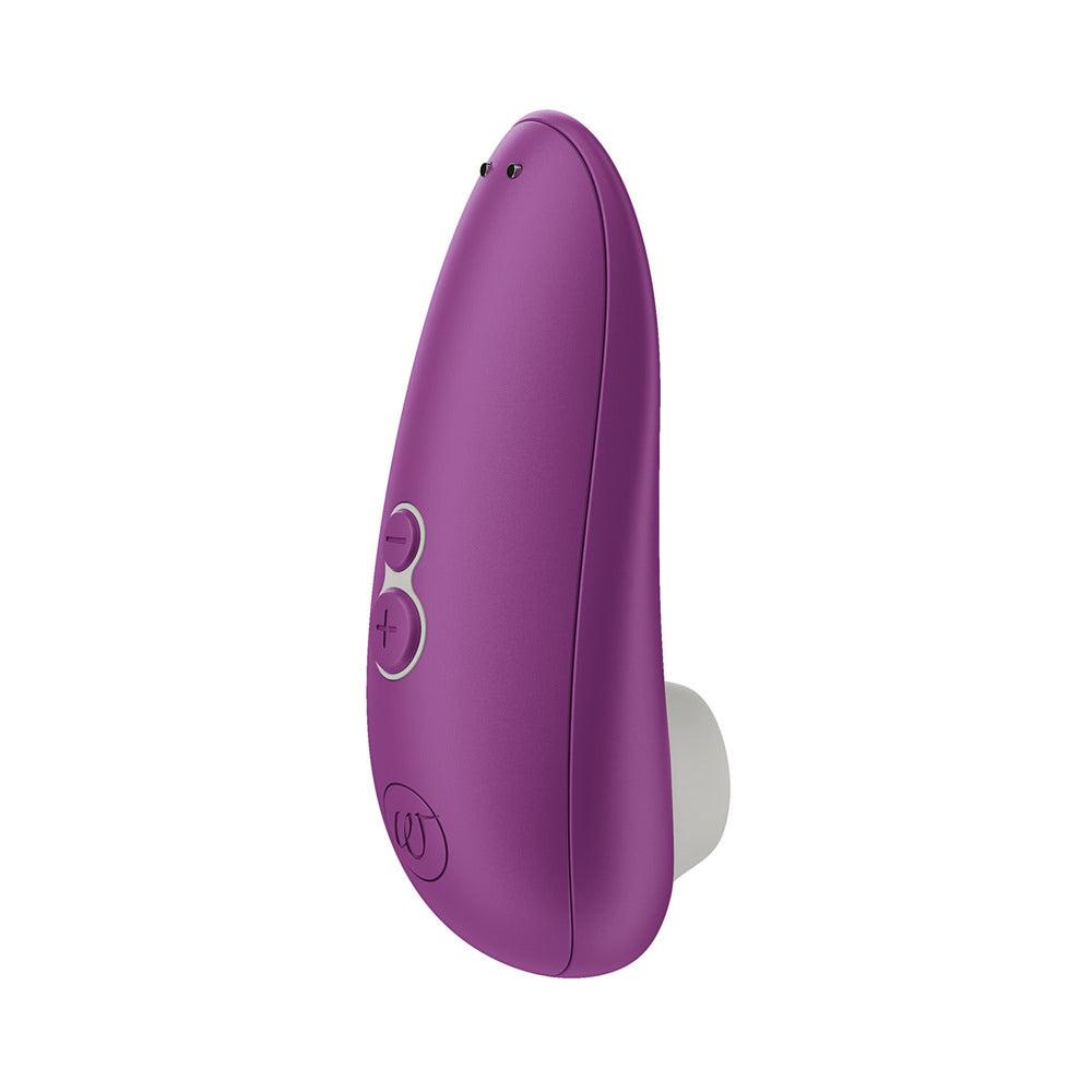 The Womanizer Starlet 3 compact air pulse clitoral stimulator standing alone in warm coral daylight, its silicone opening poised at the quiet moment right before the seal, no hands in frame.
