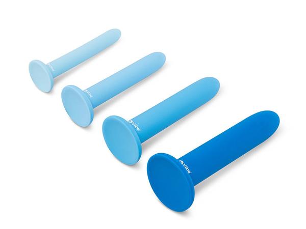 A blue silicone anal training dilator set in rising widths, four pieces each with a flat round base, lined up on white in bright daylight
