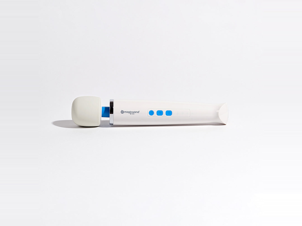 The Magic Wand Mini rechargeable vibrator lying on its side on a bright white studio surface, its rounded silicone head and slim body shown at true scale with generous open space around it, illustrating the mid-size tier between compact bullets and full-size wands.