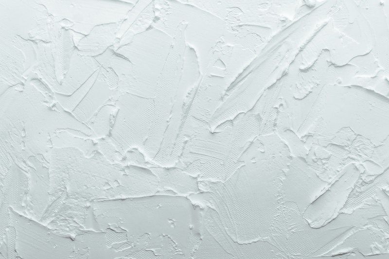 A closeup of a bright white textured wall