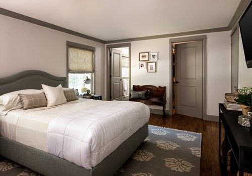 A bedroom that uses gray molding to contrast the ceiling and walls