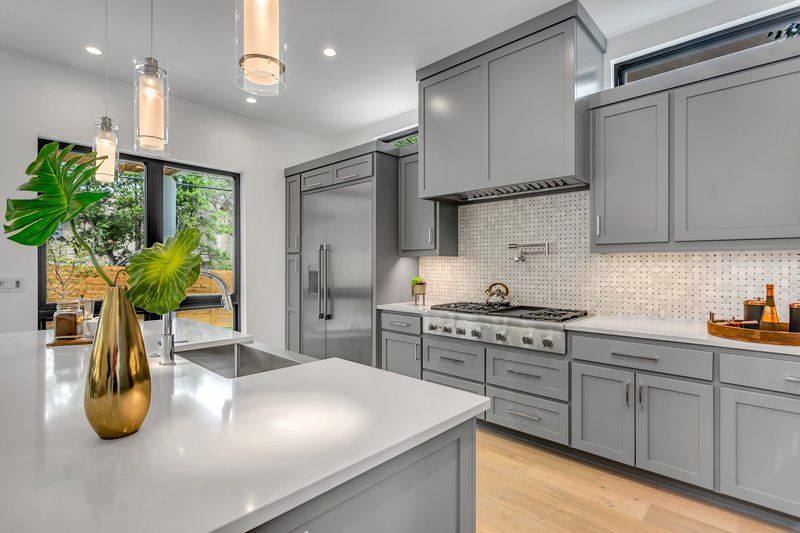 A bright kitchen with grey cabinets and interior