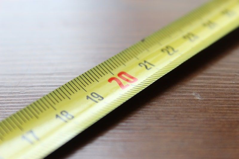 Focus on tape measure sitting along a table