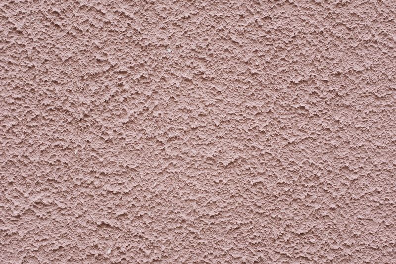 A closeup of the painted stucco texture on a wall