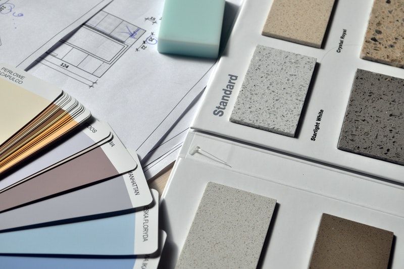 Paint swatches next to tile samples and floor plans