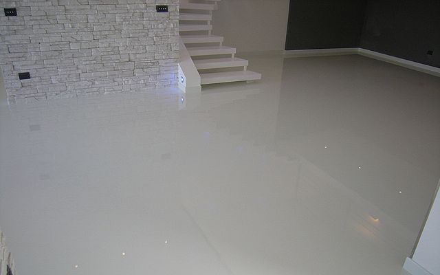 A basement floor coated in white epoxy