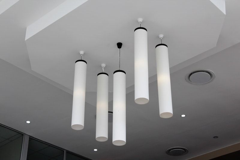 Closeup of a white ceiling with hanging lights