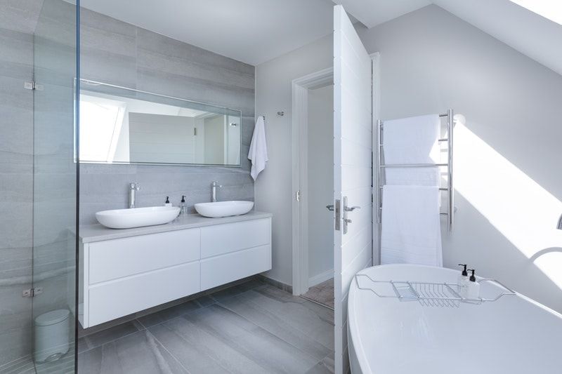 A bright, white bathroom with chips in the door