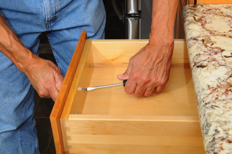 Person installing a new kitchen drawer
