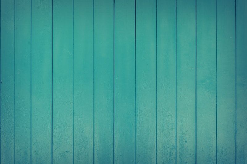 A closeup of wood paneling that has been painted teal