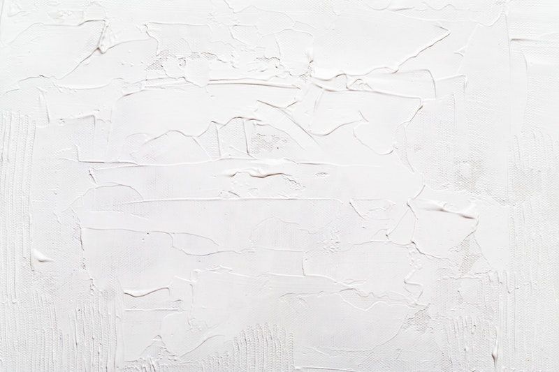 A closeup of a white textured wall
