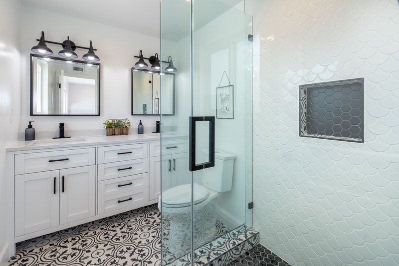 A beautiful bathroom with white painted cabinets