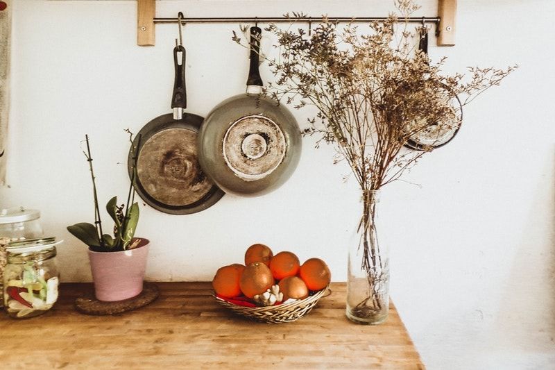 Pans hanging over counter along the kitchen wall