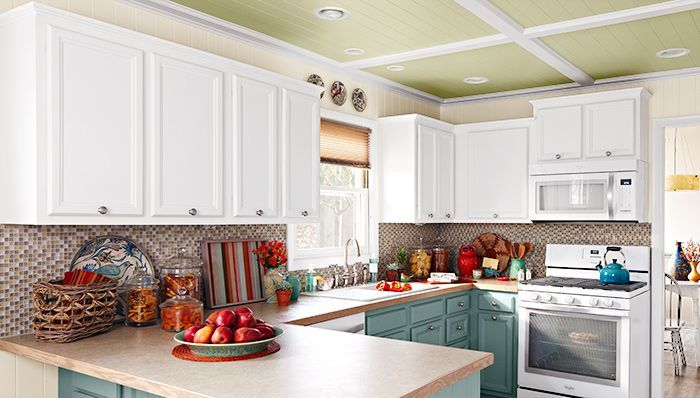 A bright kitchen with crown molding running along the top of the cabinets