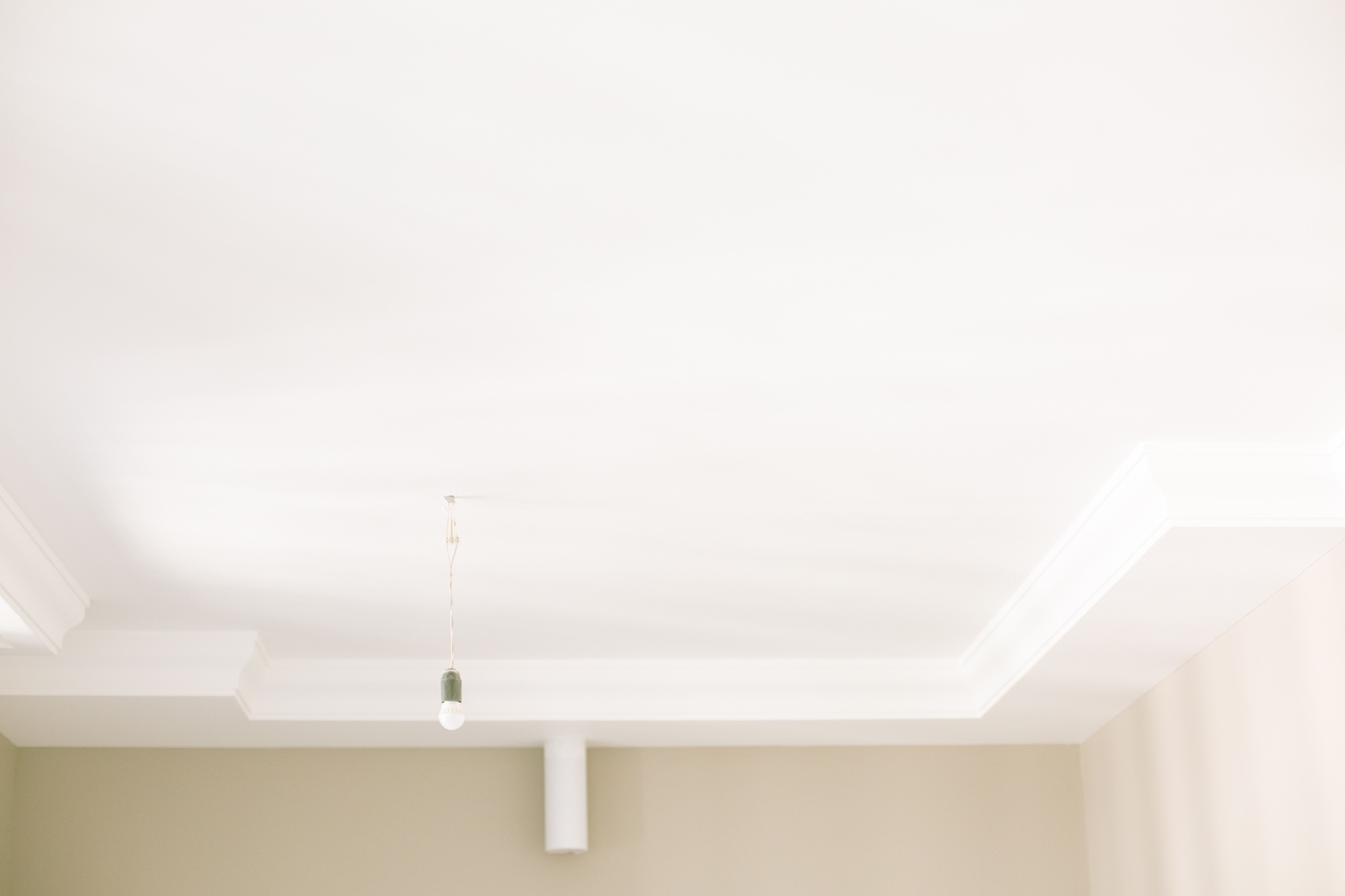 A closeup of a bright white painted ceiling
