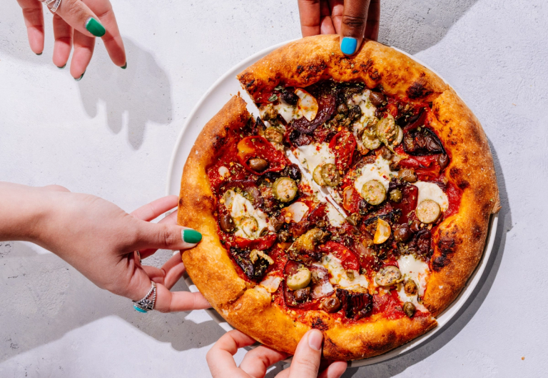 Hands reaching for New Culture's animal-free, dairy mozzarella