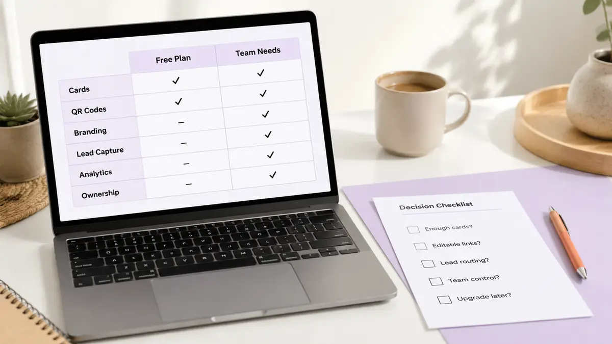 Laptop displaying a plan comparison table, and a paper decision checklist next to a coffee mug.