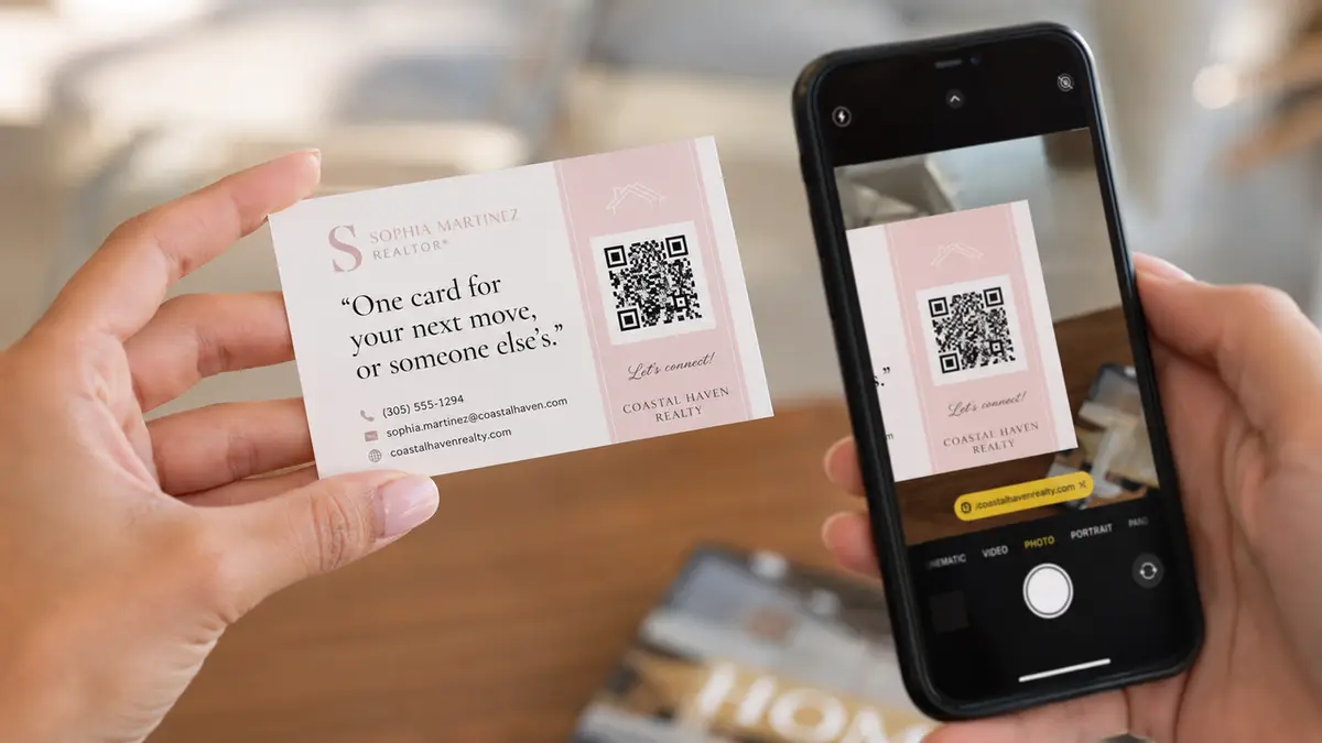 Scanning a card with a smartphone to save contact details and impactful realtor business card quotes.