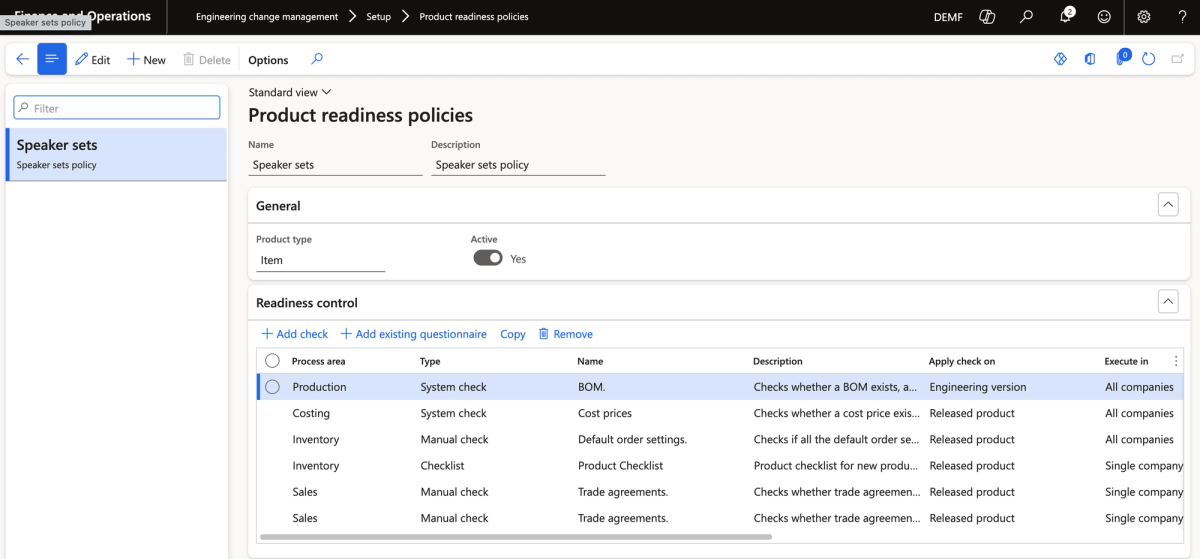 The Product Readiness Policies setup screen, showing a mix of system checks (like cost prices and BOM validation) and manual checks (like default order settings and trade agreements) configured for a Speaker Sets policy.
