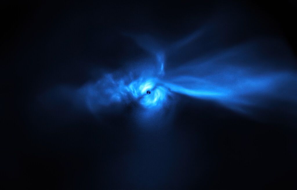 A blue irregular nebula (resembling a bird) around a star-forming disk