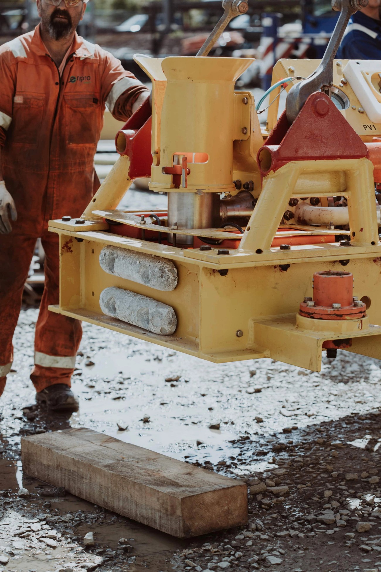 Person in boiler suit working on subsea tool in a machine yard