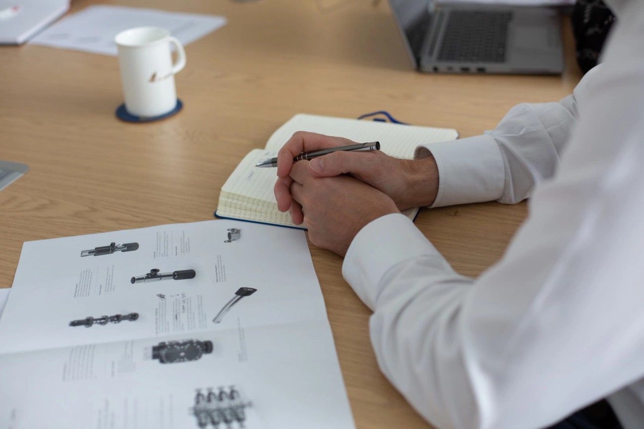 Person in white shirt taking notes